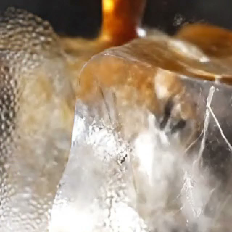 A crop of the 720p frame: the cold brew glass, soft and blocky at this size